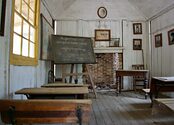 An old one room schoolhouse, in disrepair.