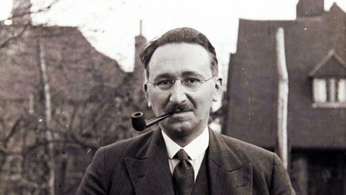 A photo of F.A. Hayek smoking a pipe outside