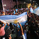 An Argentinian crowd waving flags in celebration of Milei's election.
