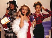 Stacey Dash, Alicia Silverstone, and Brittany Murphy stand on stairs, holding cell phones to their ears.