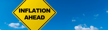 A yellow road sign against a blue sky reads "Inflation Ahead."