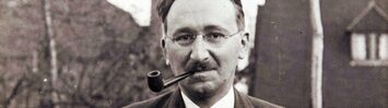 A photo of F.A. Hayek smoking a pipe outside